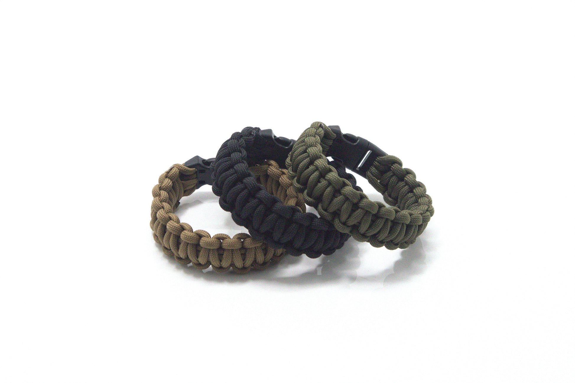 Three paracord 550 solomon knot tactical survival bracelets in brown, black, and green on a white background